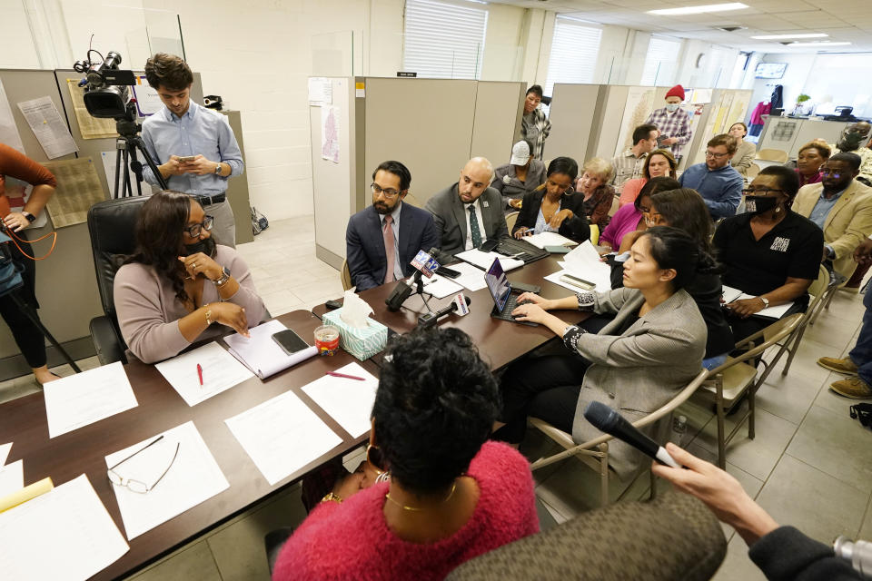 Commissioner RaToya Gilmer McGee, seated left, addresses representatives of a coalition of national and local civil rights organizations during a special meeting of the Hinds County Election Commission, Monday, Dec. 18, 2023, in Jackson, Miss. The commissioners said ballot shortages, technical mishaps and insufficient training were some of the factors that hampered voting in Mississippi's largest county during the Nov. 7 general election. (AP Photo/Rogelio V. Solis)