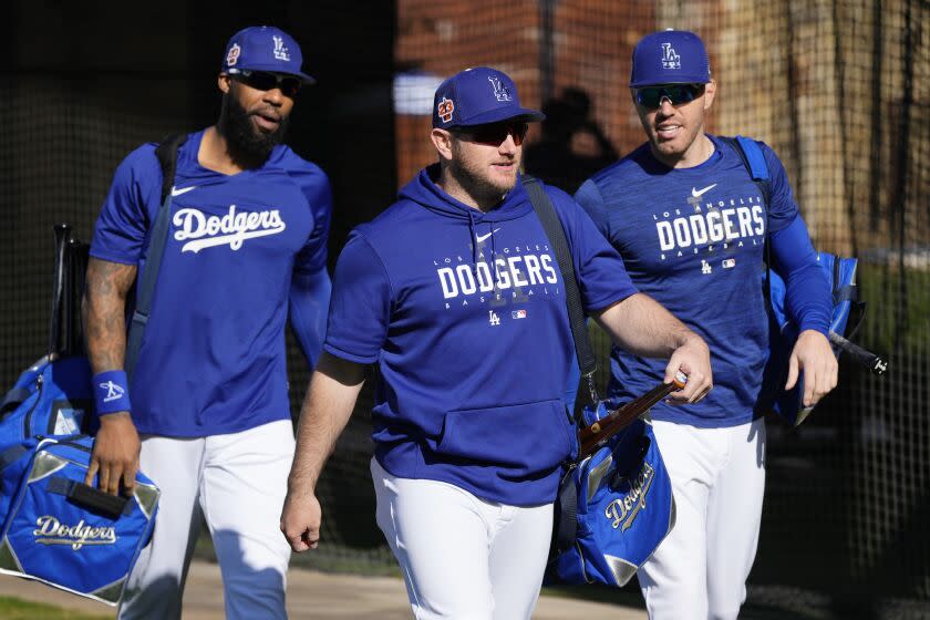 Los Angeles Dodgers' Jason Heyward, left, Max Muncy, center, and Freddie Freeman walk to the practice fields prior to spring training baseball workouts for Dodgers players in Phoenix, Monday, Feb. 20, 2023. (AP Photo/Ross D. Franklin)