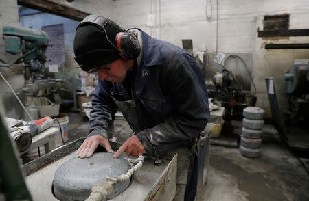 Factory worker Danny Bodie smoothes a curling stone in Kays Factory in Mauchline, Scotland, Britain, January 11, 2018. REUTERS/Russell Cheyne