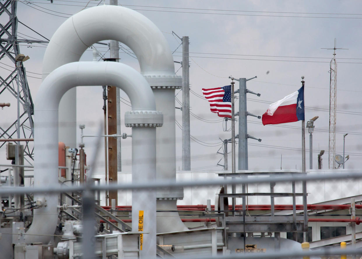 A maze of crude oil pipe and equipment is seen with the American and Texas flags flying in the background during a tour by the Department of Energy at the Strategic Petroleum Reserve in Freeport, Texas, U.S. June 9, 2016.  REUTERS/Richard Carson