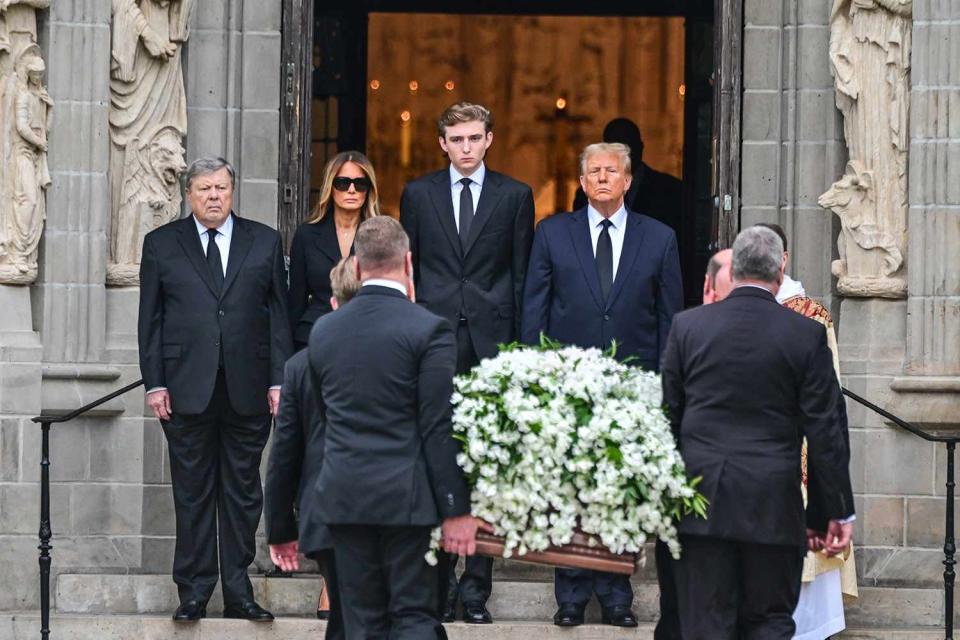 <p>GIORGIO VIERA/AFP via Getty</p> Viktor Knavs, Melania Trump, Barron Trump and Donald Trump greet the casket of Amalija Knavs