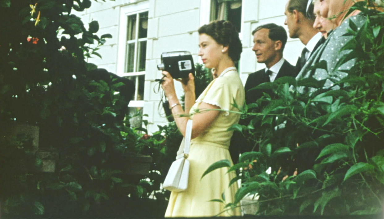 A young Queen films with a Cine camera 
at a private house, as a guest of the Governor General of New Zealand, Sir Willoughby Norrie (not shown) on Christmas Day, 1953. (Factual Fiction)





