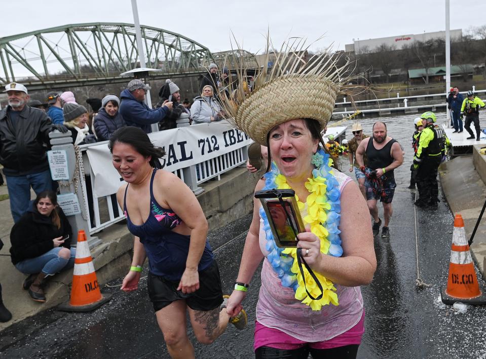 Team New Brighton Ice Lions exits the icy Beaver River during the 10th Beaver County Polar Plunge in Bridgewater.