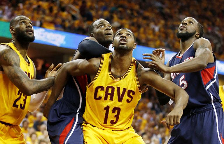 Tristan Thompson (2nd R) of the Cleveland Cavaliers vies for position with the Atlanta Hawks' Paul Millsap (2nd L) and DeMarre Carroll (R) during Game Three of the Eastern Conference Finals at Quicken Loans Arena on May 24, 2015