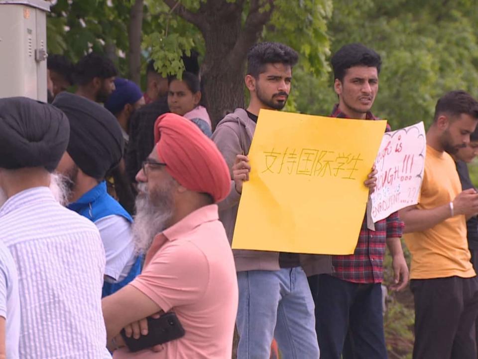 Students protested outside Alpha College of Business and Technology — an affiliate of St. Lawrence College — after they say it took a unilateral decision to suspend their enrolment, even though they had already paid thousands of dollars for tuition. (CBC - image credit)