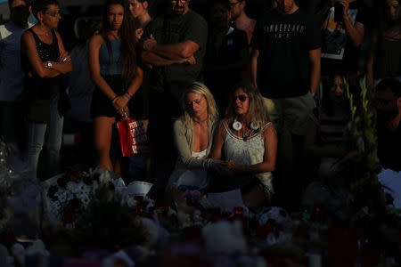 People react at an impromptu memorial where a van crashed into pedestrians at Las Ramblas in Barcelona, Spain, August 20, 2017. REUTERS/Susana Vera