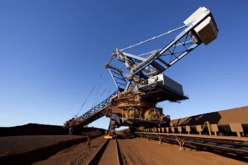 A reclaimer hauls ore deposits at the Fortescue's Herb Elliot Port in western Australia. Last weekFortescue Metals decided to defer several planned expansions and slash capital spending by US$1.6 billion to cope with commodity price volatility