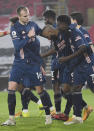 Arsenal's Alexandre Lacazette, centre, celebrates with team mates after scoring his side's third goal during an English Premier League soccer match between Southampton and Arsenal at the St Mary's stadium in Southampton, England, Tuesday Jan. 26, 2021. (Andy Rain/Pool via AP)