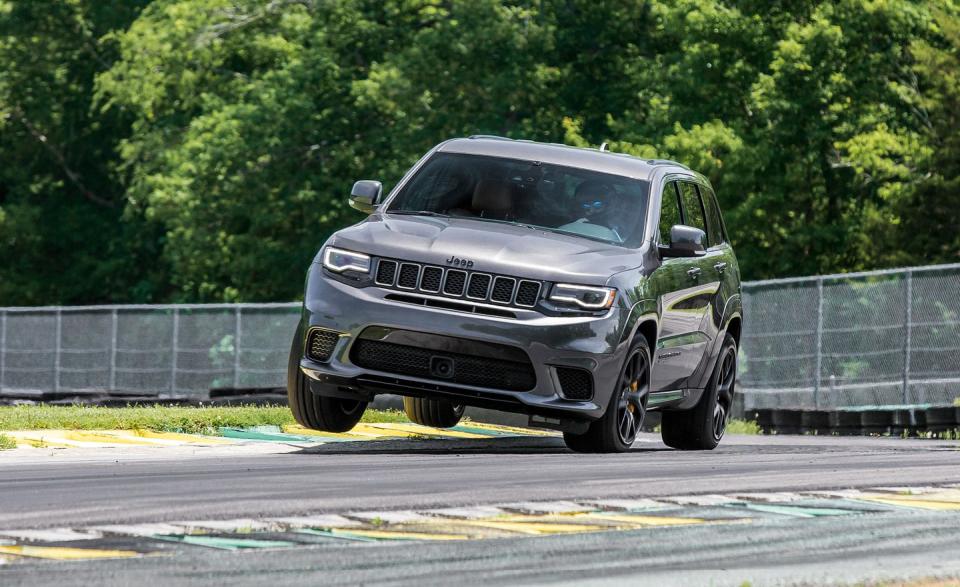 <p>This photo from our 2018 Lightning Lap coverage generated a lot of comments on our website, some positive, some negative. To clear the air, no, <a rel="nofollow noopener" href="https://www.caranddriver.com/features/2018-jeep-grand-cherokee-trackhawk-lightning-lap-2018" target="_blank" data-ylk="slk:the Jeep Grand Cherokee Trackhawk;elm:context_link;itc:0;sec:content-canvas" class="link ">the Jeep Grand Cherokee Trackhawk</a> didn't roll over after this shot was taken. Nor, at any point during the exercise, did it feel as if it might. The two-wheeled dance was the natural result of pounding the 707-hp Jeep into Virginia International Raceway's painted curbing lining the inside of the Oak Tree corner at high speed at the request of our photographers. We swear it definitely, probably wasn't going to tip over.</p>