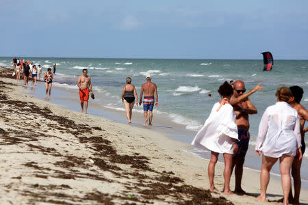 Tourists walk at the beach in Varadero, Cuba, December 7, 2018. Picture taken December 7, 2018. REUTERS/Fernando Medina