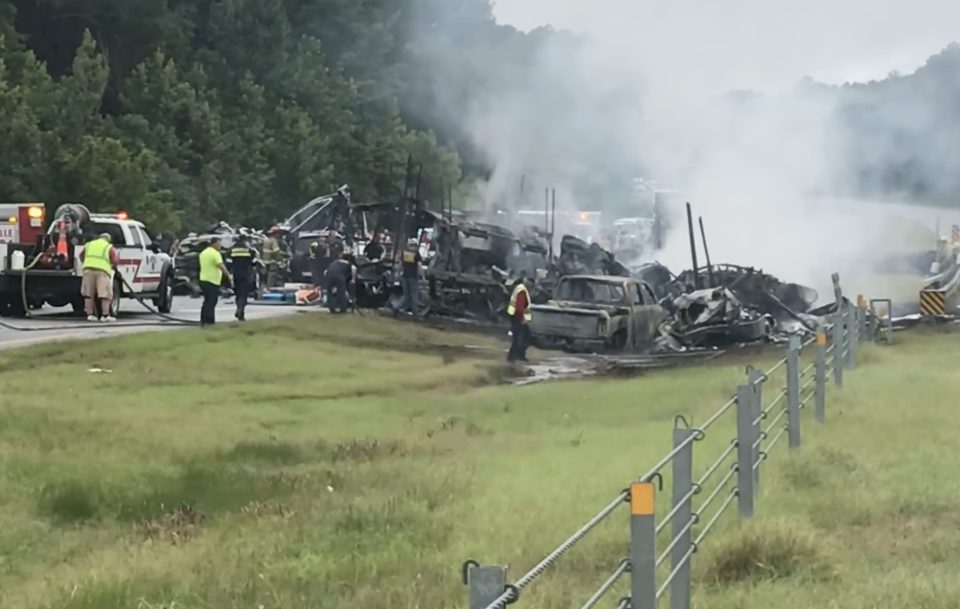 A smouldering 15-car pile up is pictured in Alabama.