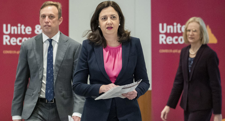 Queensland Deputy Premier Steven Miles, Queensland Premier Annastacia Palaszczuk and Queensland Chief Health Officer Dr Jeannette Young arrive to speak to the media during a press conference in Brisbane.