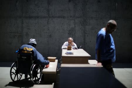 Inmate William Michael Dalby, 70, (C) sits in the yard of a cellblock which mainly houses prisoners with cognitive decline, Alzheimer's, and dementia, at the California Health Care Facility in Stockton, California, U.S., May 24, 2018. REUTERS/Lucy Nicholson