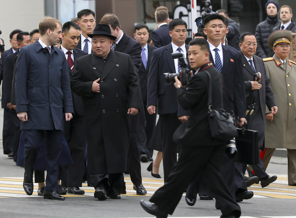 In this photo released by the press office of the administration of Primorsky Krai region, North Korea's leader Kim Jong Un, center left, surrounded by Russian and North Korea's officials arrive in Vladivostok, Russia, Wednesday, April 24, 2019. North Korean leader Kim Jong Un arrived in Russia on Wednesday morning for his much-anticipated summit with Russian President Vladimir Putin in the Pacific port city of Vladivostok. (Igor Novikov/Press Office of the Primorye Territory Administration via AP)