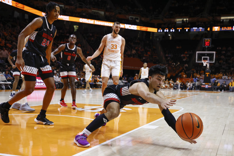 Austin Peay guard Carlos Paez (1) dives for the ball during the first half of the team's NCAA college basketball game against Tennessee, Wednesday, Dec. 21, 2022, in Knoxville, Tenn. (AP Photo/Wade Payne)