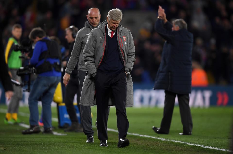 Arsene Wenger bows his head as he leaves the Selhurst Park pitch