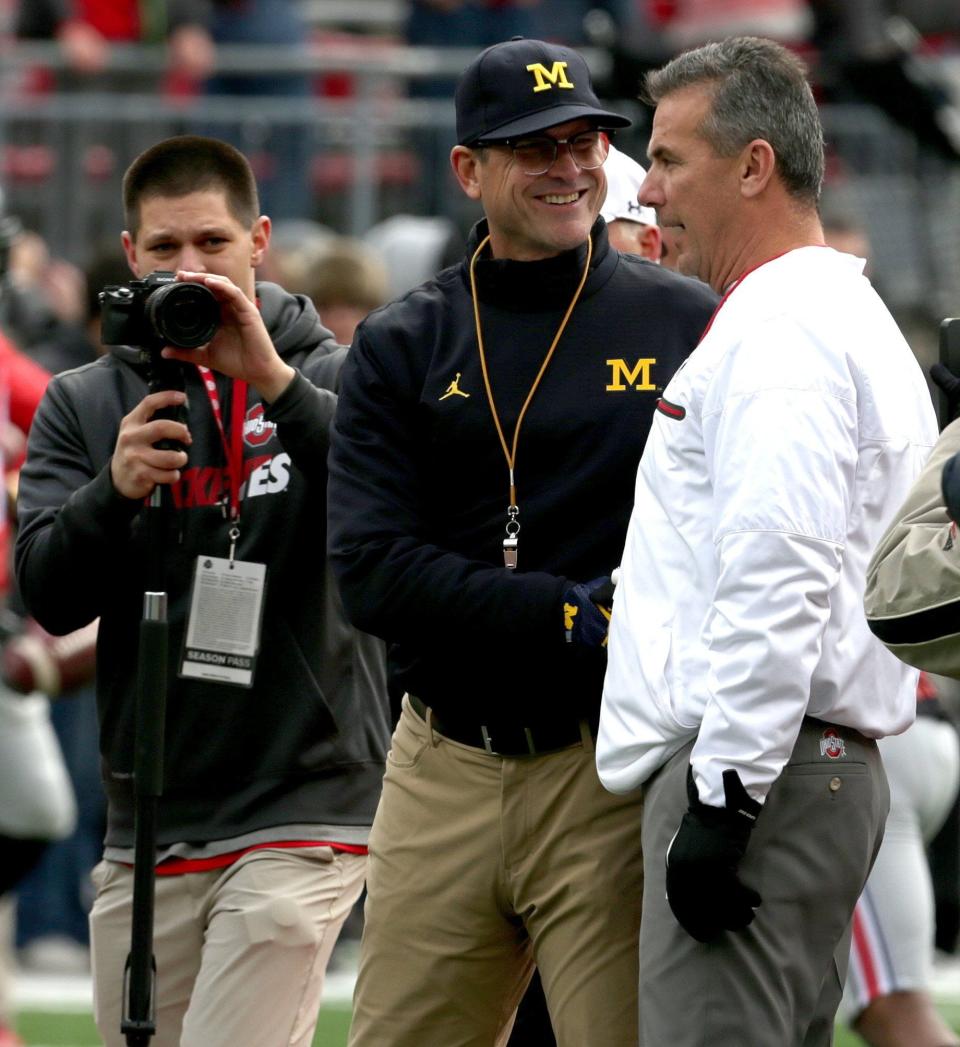 Michigan coach Jim Harbaugh and Ohio State coach Urban Meyer shake hands at midfield before the game at Ohio Stadium in Columbus, Ohio on Nov. 26, 2016.