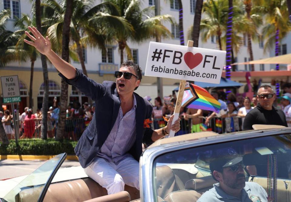 Fabian Basabe waves to the crowd as he is met with protest on Ocean Drive during the Miami Beach Pride Parade on April 16, 2023.