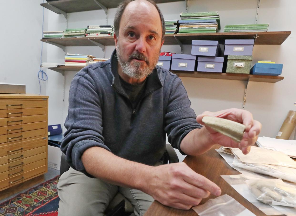 Timothy Matney, University of Akron archaeology professor, holds a piece of a storage vessel dating back to 900-600 B.C. from a dig in the Kurdish region of Iraq.