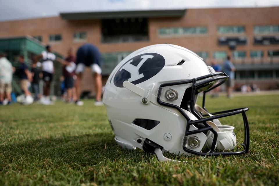 A helmet is pictured on the grass after BYU football practice at Brigham Young University in Provo on Tuesday, Aug. 1, 2023. | Spenser Heaps, Deseret News