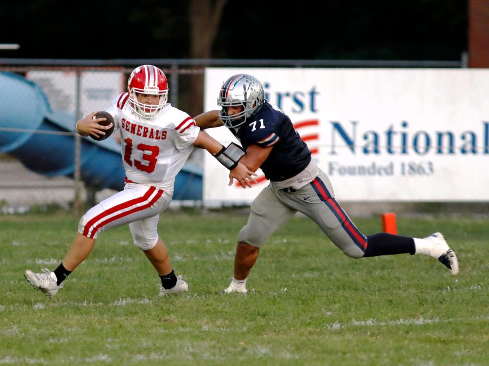 Morgan's Wade Pauley tries to sack Sheridan quarterback Caden Sheridan during the first half on Friday night in McConnelsville. Sheridan won, 18-13, to improve to 3-1.