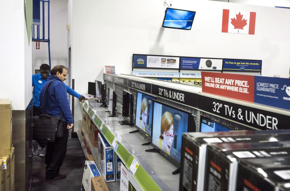 A customer shops for a flat screen tv at a Best Buy store during Black Friday sales in Toronto on Friday, Nov. 27, 2015. (CP)