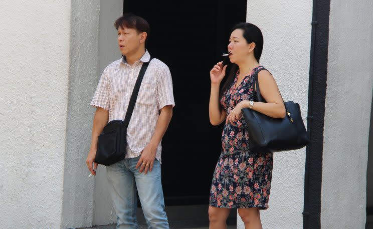 Two people smoking outside Cuppage Terrace, located at Orchard Road on Friday (30 June) afternoon. (Photo: Gabriel Choo/ Yahoo Singapore)