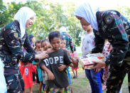 Government female soldiers wearing white hijabs distribute candies and goodies as part of their psychosocial activities at one of the evacuation centres in Iligan city, southern Philippines, September 8, 2017. REUTERS/Romeo Ranoco