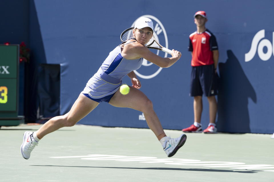 Romania's Simona Halep reaches for a return to United States' Jessica Pegula during the National Bank Open tennis tournament in Toronto, Saturday, Aug. 13, 2022. (Chris Young/The Canadian Press via AP)