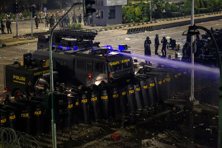 Police disperse protesters with a water cannon in Jakarta, Indonesia May 23, 2019 in this photo taken by Antara Foto. Antara Foto/Dhemas Reviyanto/ via REUTERS