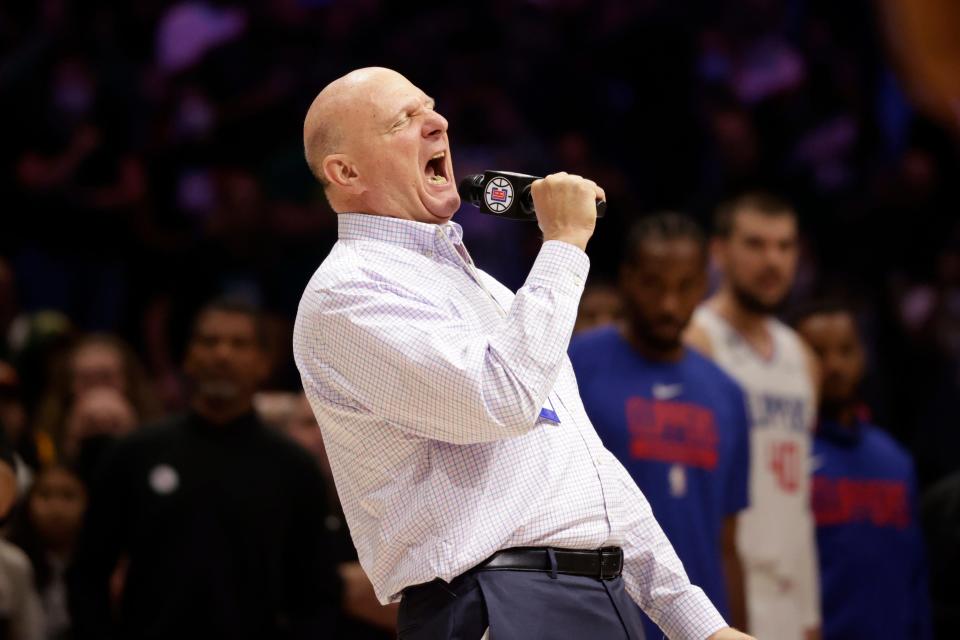 Los Angeles Clippers owner Steve Ballmer welcomes fans to a preseason NBA basketball game against the Portland Trail Blazers.