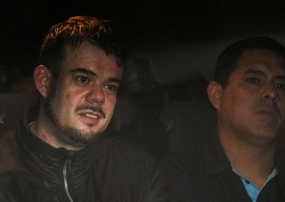 FILE - Dutch citizen Joran van der Sloot, left, is driven in a police vehicle from a maximum-security prison to an airport to be extradited to the U.S., on the outskirts of Lima, Peru, Thursday, June 8, 2023. Court records filed Friday, Oct. 13, indicate Van der Sloot, the chief suspect in Natalee Holloway’s 2005 disappearance, intends to plead guilty in a federal case accusing him of trying to extort money from the missing teen’s mother. (AP Photo/Martin Mejia, File)