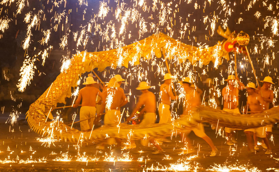 Folk artists perform a dragon dance in the splash of molten iron to celebrate the Lantern Festival at Huanglongxi in Chengdu, Sichuan province, China, on Feb. 5, 2023.