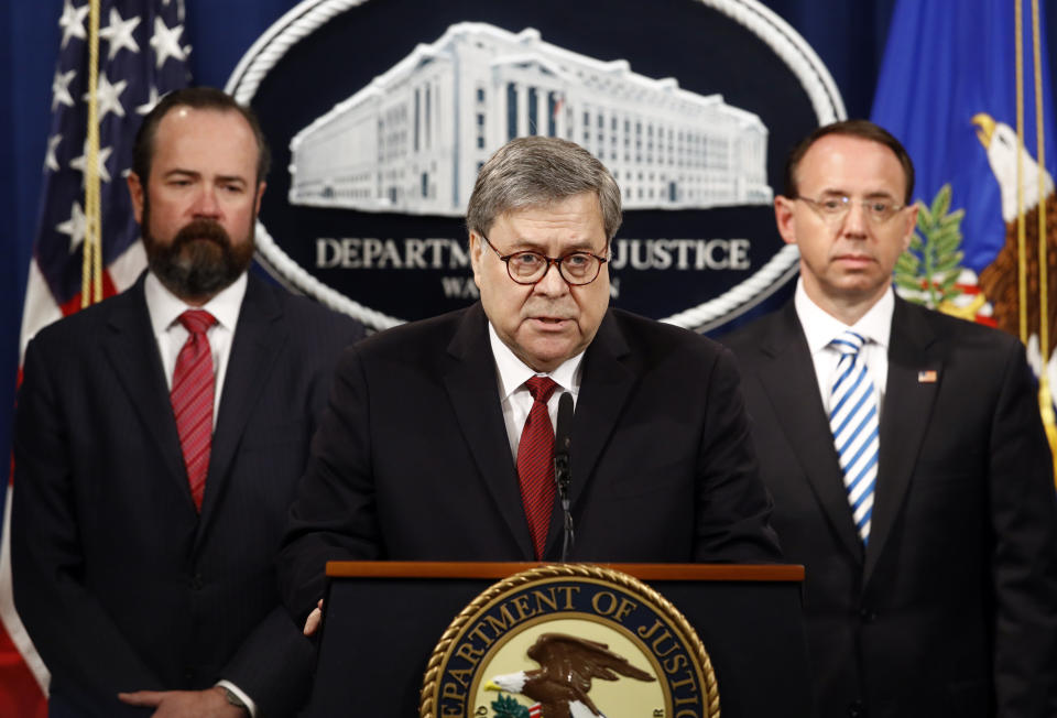 Attorney General William Barr speaks alongside Deputy Attorney General Rod Rosenstein, right, and acting Principal Associate Deputy Attorney General Edward O'Callaghan, left, about the release of a redacted version of special counsel Robert Mueller's report during a news conference, Thursday, April 18, 2019, at the Department of Justice in Washington. (AP Photo/Patrick Semansky)