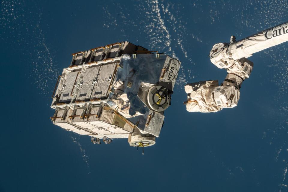 An external pallet packed with old nickel-hydrogen batteries is released from the Canadarm2 robotic arm
