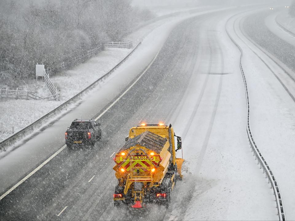 A salt-spreading vehicle makes its way down the M47 in Abington, Scotland (Getty)