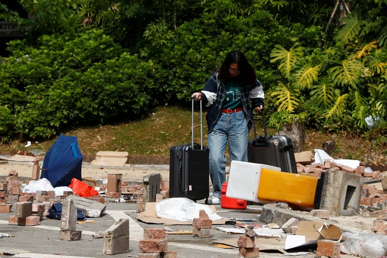 A mainland Chinese student leaves the campus of Hong Kong Baptist University, Hong Kong