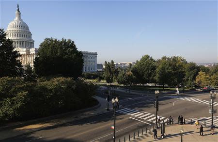 A few pedestrians wait to cross the street to the U.S. Capitol in Washington, October 2, 2013. REUTERS/Jonathan Ernst