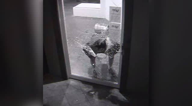After smashing a hole in the door with the keg, the man embarks on his first attempt to get inside. Photo: Supplied
