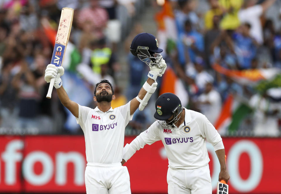India's Ajinkya Rahane, left, celebrates after scoring a century as teammate Ravindra Jadeja watches during play on day two of the second cricket test between India and Australia at the Melbourne Cricket Ground, Melbourne, Australia, Sunday, Dec. 27, 2020. (AP Photo/Asanka Brendon Ratnayake)