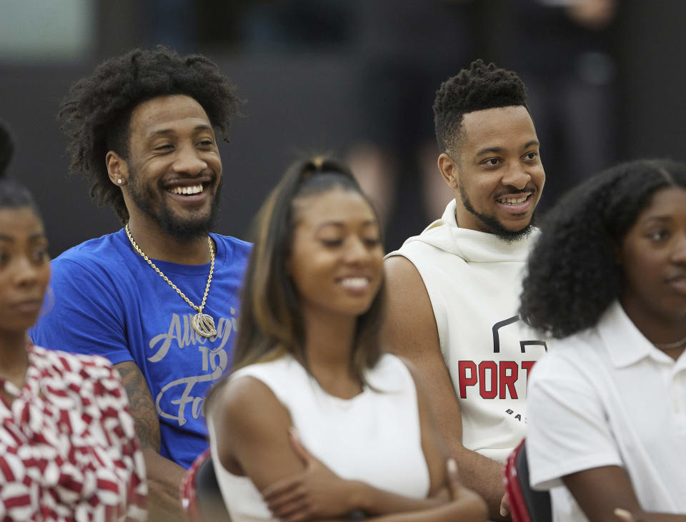 Portland Trail Blazers players Robert Covington, left, and CJ McCollum smile during a press conference announcing Chauncey Billups as the head coach of the at the team's practice facility in Tualatin, Ore., Tuesday, June 29, 2021. (AP Photo/Craig Mitchelldyer)