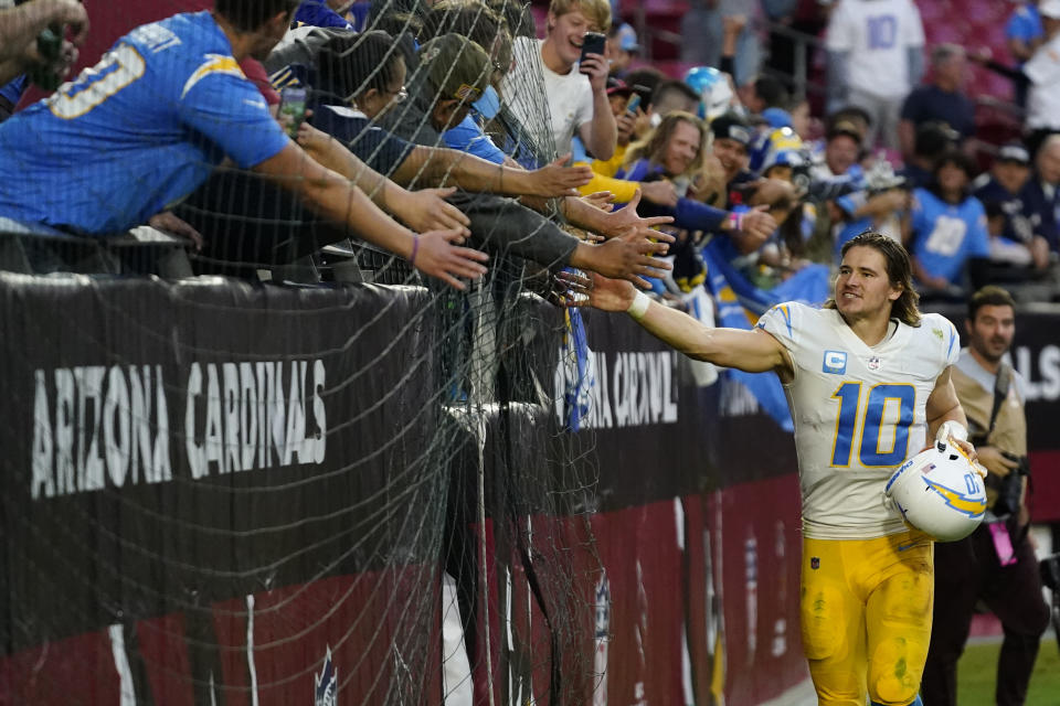 Los Angeles Chargers quarterback Justin Herbert (10) greets fans after an NFL football game against the Arizona Cardinals, Sunday, Nov. 27, 2022, in Glendale, Ariz. The Chargers defeated the Cardinals 25-24. (AP Photo/Ross D. Franklin)