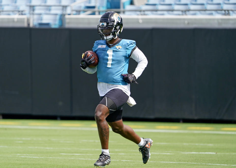 Jacksonville Jaguars running back Travis Etienne (1) practices a punt return drill during an NFL football practice, Monday, May 23, 2022, in Jacksonville, Fla. (AP Photo/John Raoux)