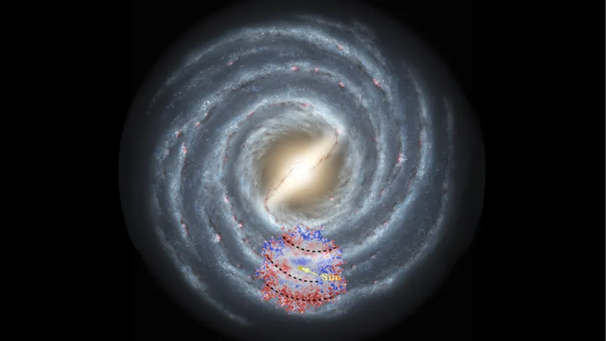  An illustration of the Milky Way with red and blue spots showing areas with few (blue) and many (red) heavy elements 