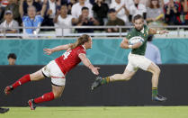 South Africa's Cobus Reinach runs clear of Canada's Jeff Hassler during the Rugby World Cup Pool B game at Kobe Misaki Stadium between South Africa and Canada in Kobe, Japan, Tuesday, Oct. 8, 2019. (Kyodo News via AP)