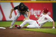 Pittsburgh Pirates' shortstop Cole Tucker (3) tags out Cincinnati Reds' Tyler Mahle (30) during the second inning of a baseball game in Cincinnati, Tuesday, Sept 21, 2021. (AP Photo/Bryan Woolston)
