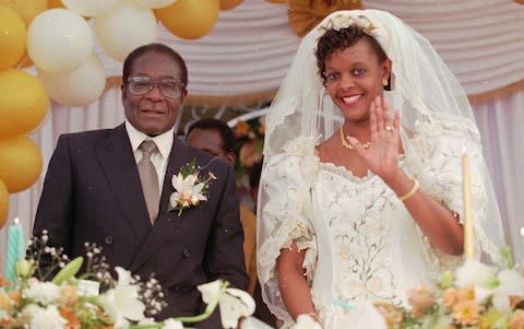 President Robert Mugabe marrying wife Grace in August 1996 - Credit: JOAO SILVA&nbsp;/AP