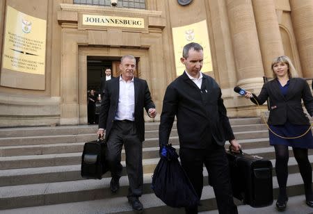 State prosecutor Gerrie Nel (L) leaves court after an appeal hearing brought by prosecutors against the six-year jail term handed to Oscar Pistorius for the murder of his girlfriend Reeva Steenkamp in Johannesburg, South Africa August 26, 2016. REUTERS/Siphiwe Sibeko