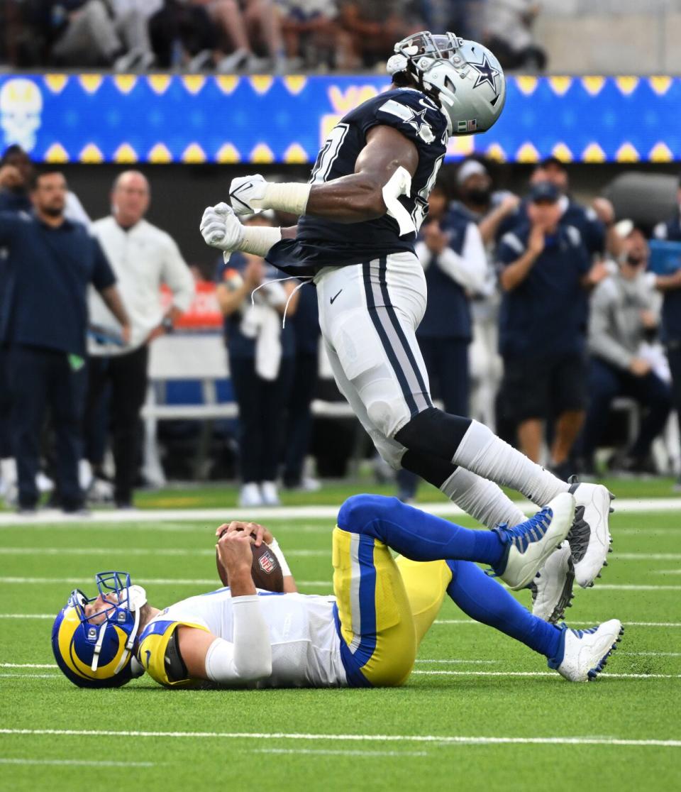 Cowboys defensive tackle Osa Odighizuwa celebrates his sack of Rams quarterback Matthew Stafford in the fourth quarter.