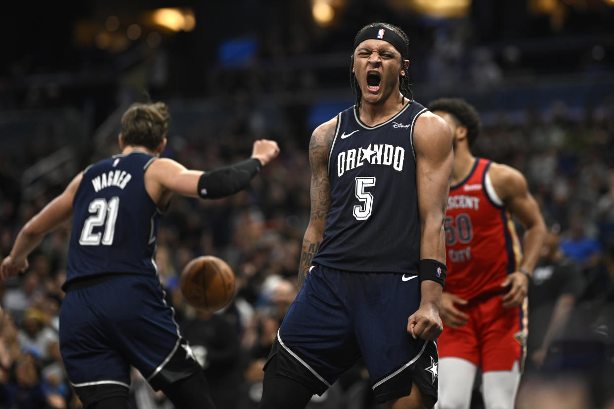 Orlando Magic forward Paolo Banchero (5) reacts after dunking during the second half of an NBA basketball game against the New Orleans Pelicans, Thursday, March 21, 2024, in Orlando, Fla. (AP Photo/Phelan M. Ebenhack)